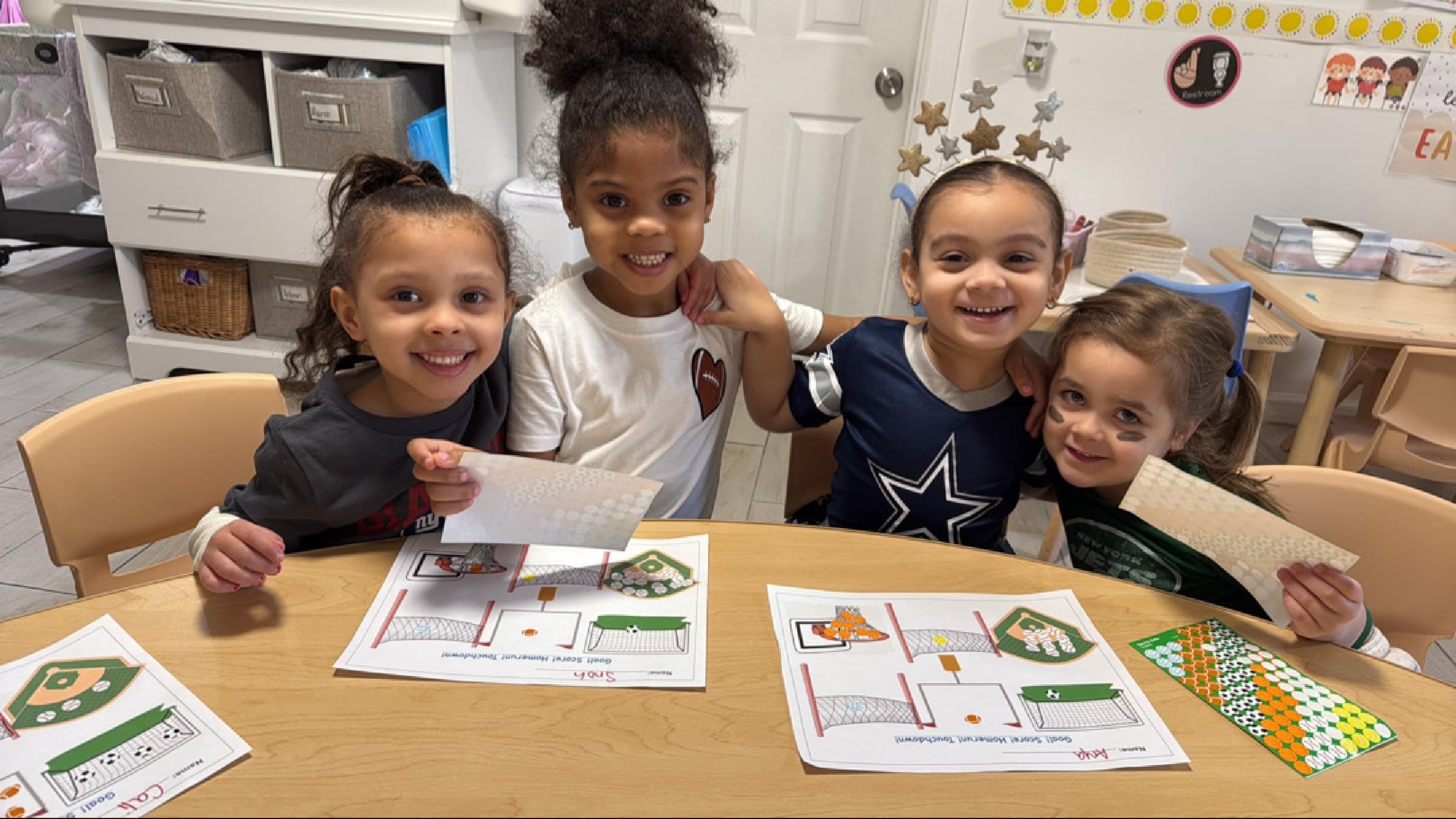 Children smiling together during a hands-on learning activity at Rising Scholars