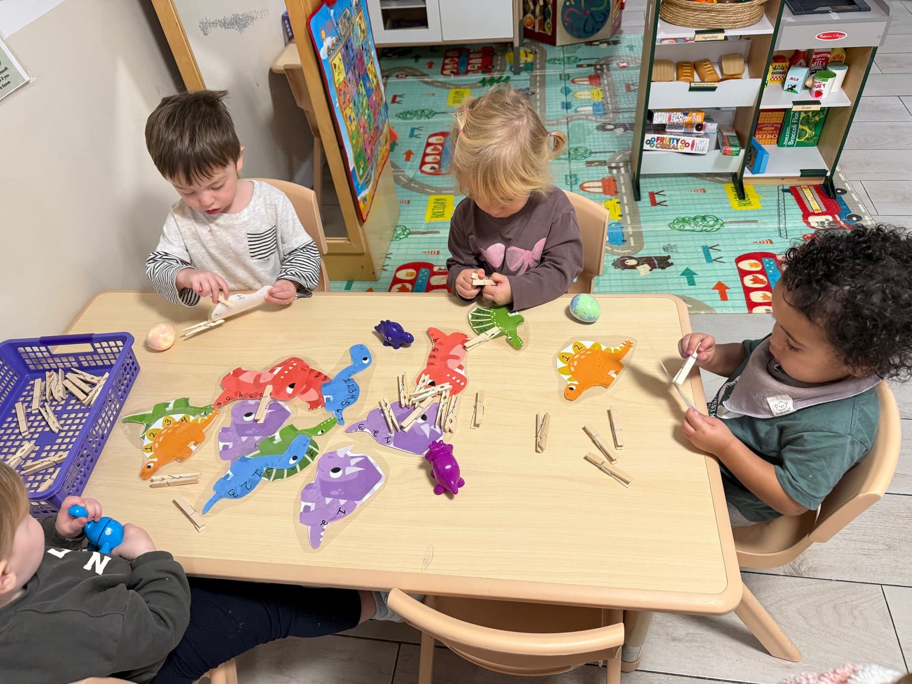 Children focused on a hands-on fine-motor learning activity with colorful materials