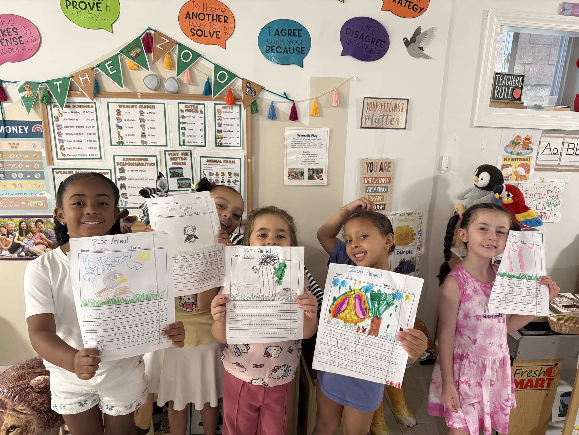 Rising Scholars toddlers proudly holding their zoo animal projects
